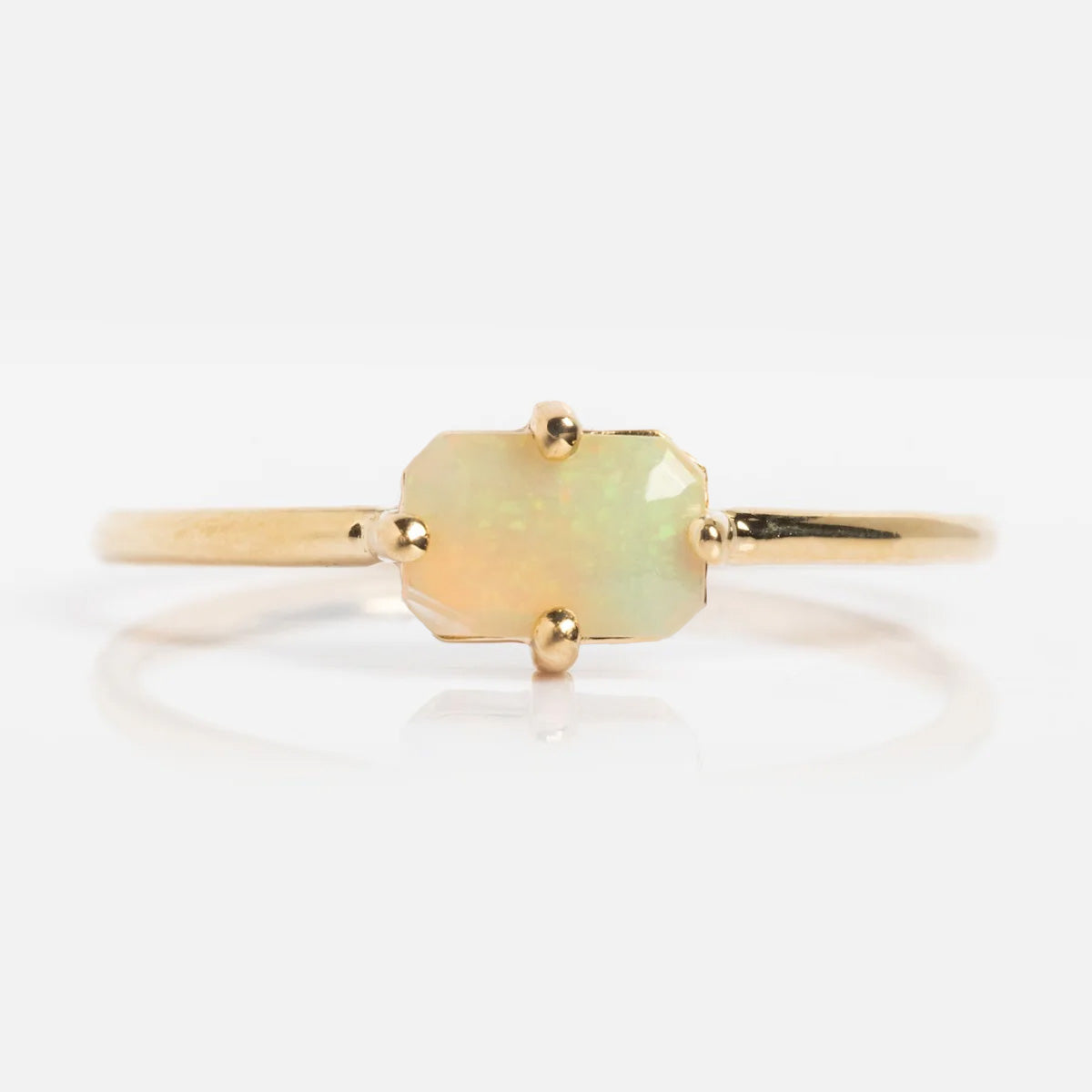 The 14k Mod Love Birthstone Ring showcases an octagonal, prong-set opal gemstone with subtle iridescent hues, set in 14k gold and displayed against a plain white background.