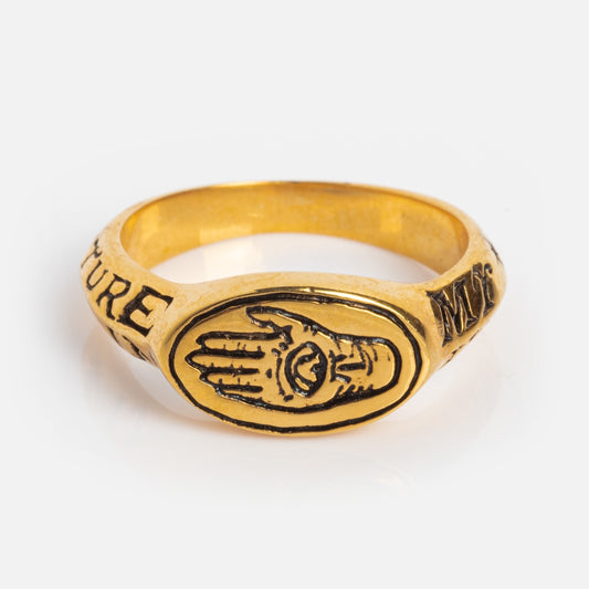 The Future In My Hands Signet Ring features an engraved hand with an eye in the palm and decorative text encircling the 18k gold vermeil band, creating a mystical, antique-inspired piece perfect as a unique jewelry statement.