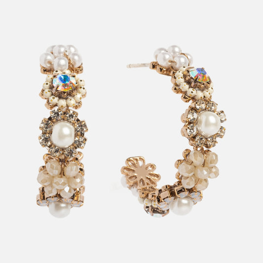 The Bloom Crystal Hoop Earrings feature gold plating, pearls, crystals, and beaded floral designs for an elegant statement look blending sparkling and pearlescent accents.