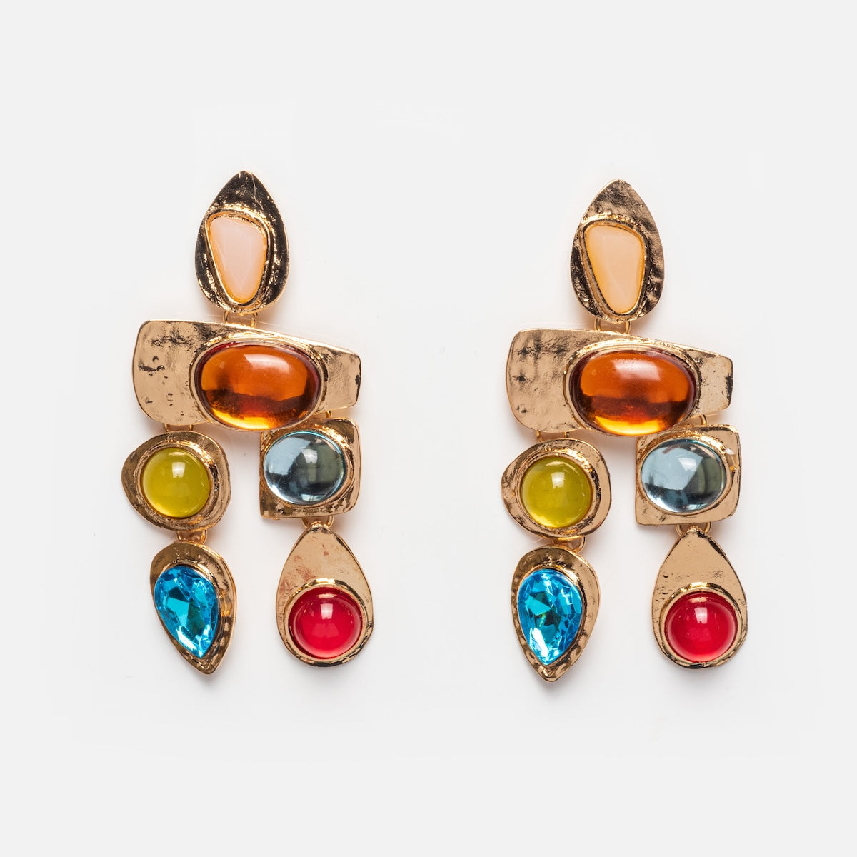 The Multi Stone Earrings are gold-tone with colorful gemstones—blue, red, yellow, orange, and white—arranged in geometric shapes on a white background.