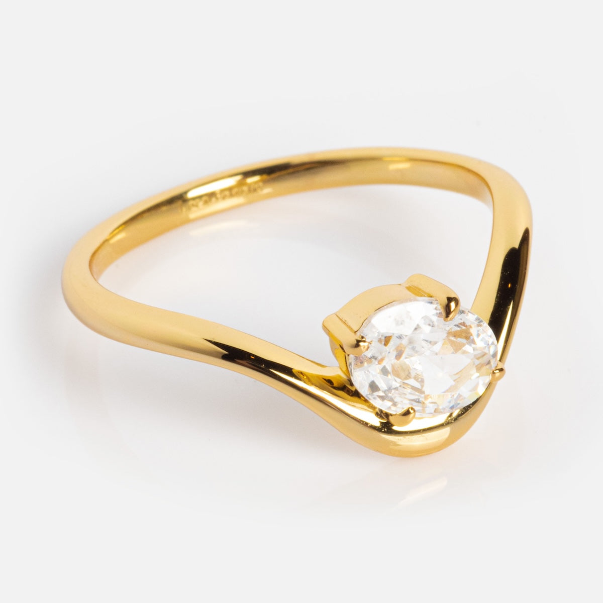 The Floating Gem Ring by Local Eclectic features a single large oval-cut clear gemstone in a prong setting on a curved 14k yellow gold plated band, shown on a white background.