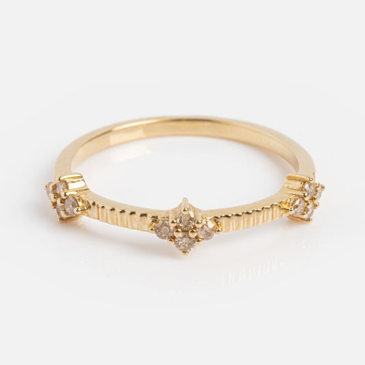 The Solid Gold Salt and Pepper Diamond Ribbed Ring features a central cluster of salt and pepper diamonds, intricate ribbed detailing along the band, and is perfect as a stacking band with diamond accents on each side.