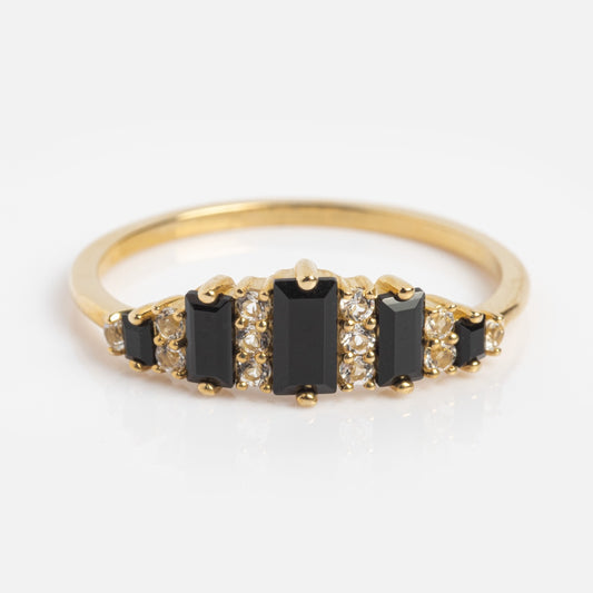 The Solid Gold Black Agate Crown Ring showcases five vertical rectangular black agate stones, each separated by small round white stones, creating a unique statement piece against a plain white background.