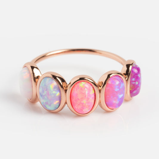 The Rose Gold Opal Ombre Candy Band showcases five oval opals in a row, each with iridescent white, blue, pink, and purple hues set against a white background.