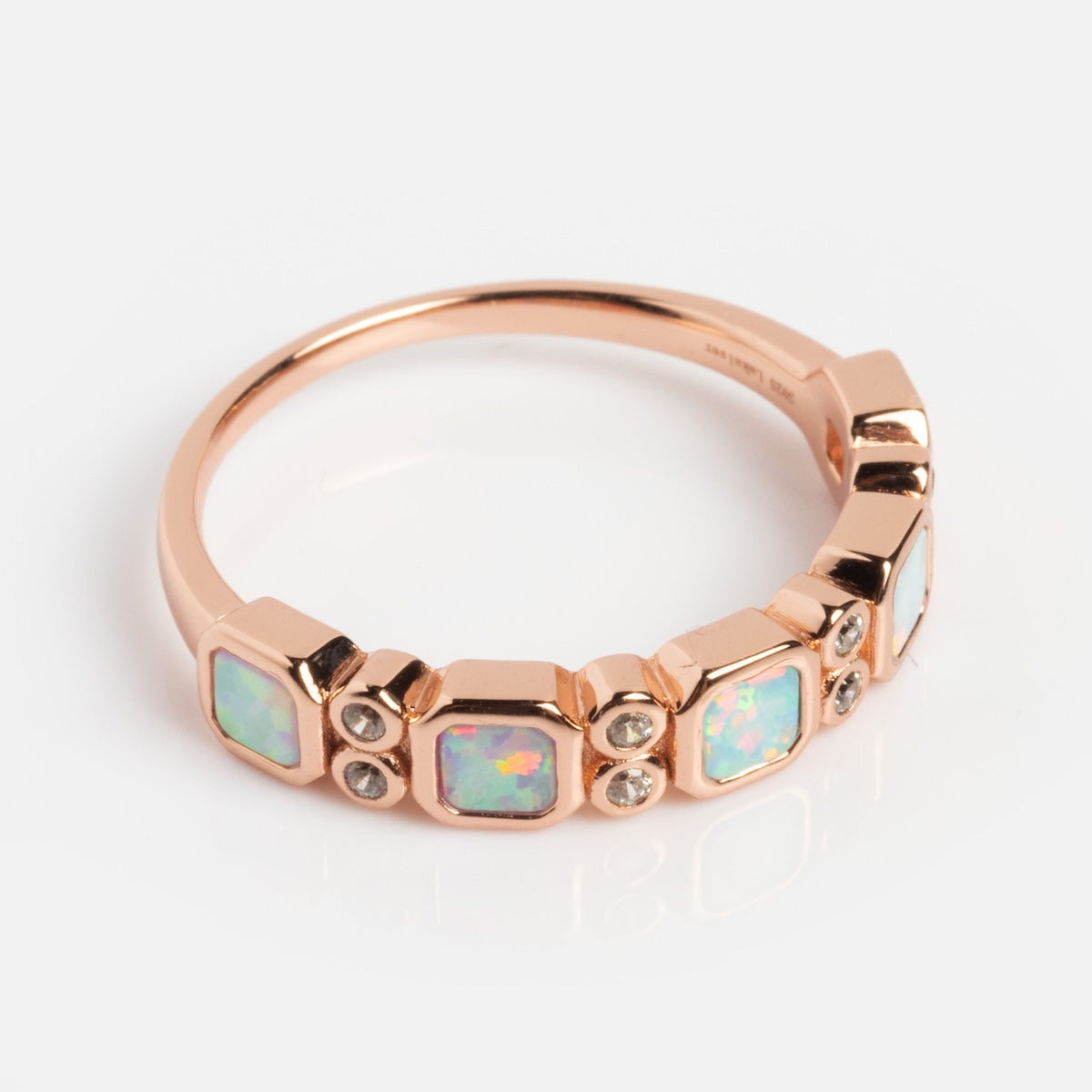 The Rose Gold Ombre Juniper Band is a 14k rose gold vermeil ring with three square simulated opals and six round diamonds in a geometric design, ideal for fans of the Rose Gold Ombre Band style.