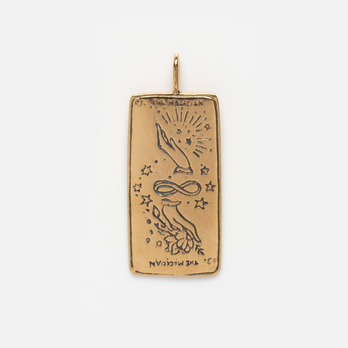 The Tarot Card Charm is a rectangular 14k solid gold piece engraved with hands, an infinity symbol, stars, rays, and THE MAGICIAN—mystical jewelry inspired by the allure and symbolism of tarot.