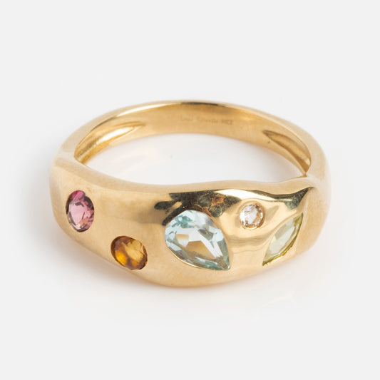 Exclusive to Local Eclectic, the Solid Gold Bold Organic Dawn Band features four colorful gemstones—including a pink tourmaline and a teardrop-shaped blue stone—set in a smooth, rounded solid gold band.
