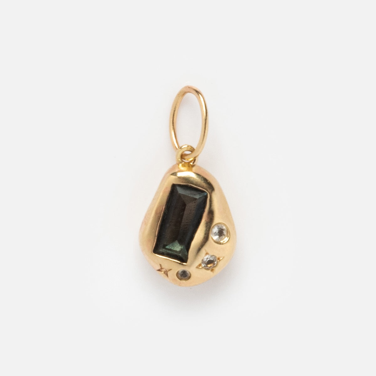 The Solid Gold Amulet Charm features an organic-shaped gold design, a rectangular dark green gemstone, two small clear stones, and a gold loop—perfect for adding to your favorite necklace.