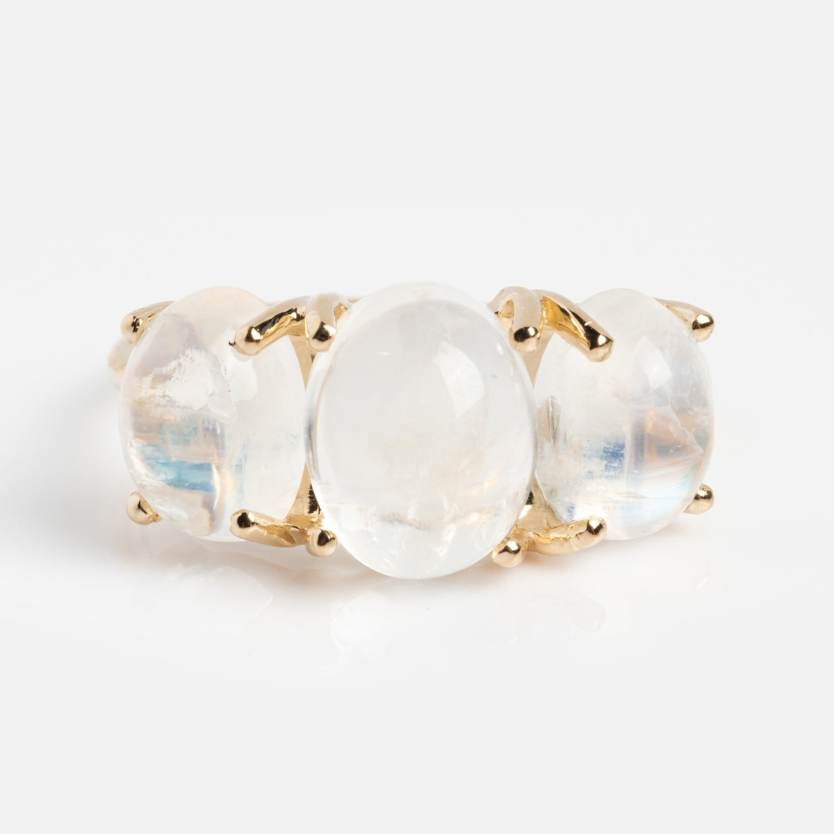 The Sweetest Gumdrop Ring, crafted in yellow gold, showcases three oval-shaped translucent moonstones set side by side in prongs on a plain band, shown against a white background.