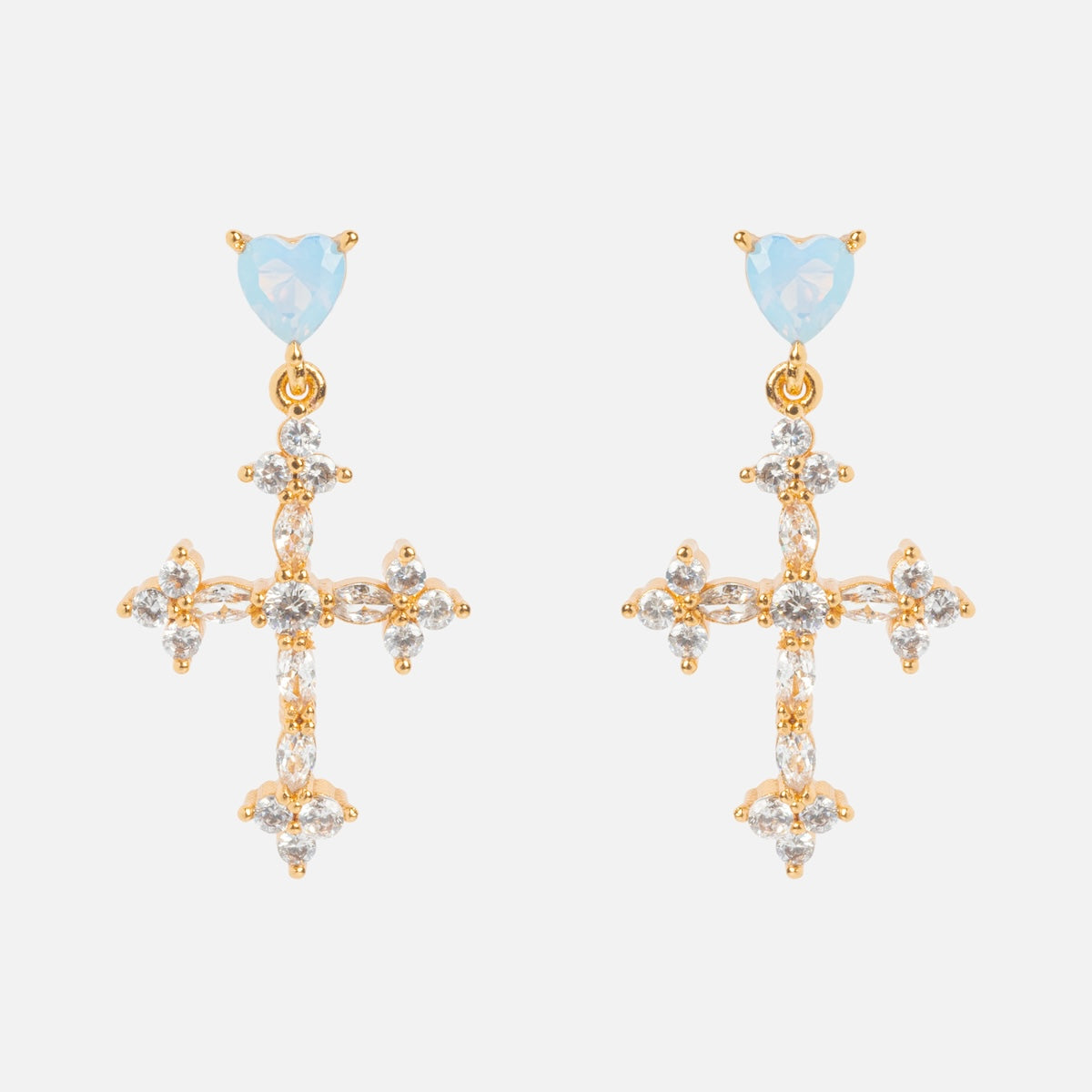 The Serendipity Cross Dangle Earrings Sample features 18k yellow gold plating, blue heart-shaped studs, dangling CZ-adorned crosses on a brass base, displayed against a white background.
