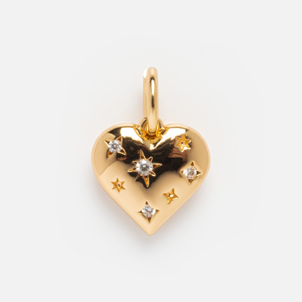 The Charms by Elizabeth Stone pendant features a heart shape in 14k gold plate, detailed with small star engravings and clear gemstones. It includes a top loop for chains and displays elegantly against a plain white background.