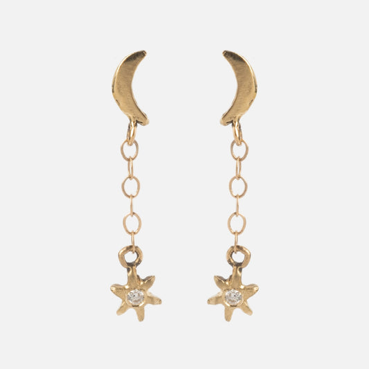 Moon and Stars Drop Earrings in 14k solid yellow gold feature crescent moon studs with a delicate chain drop ending in a star charm accented by a clear central gem, showcased on a plain white background.