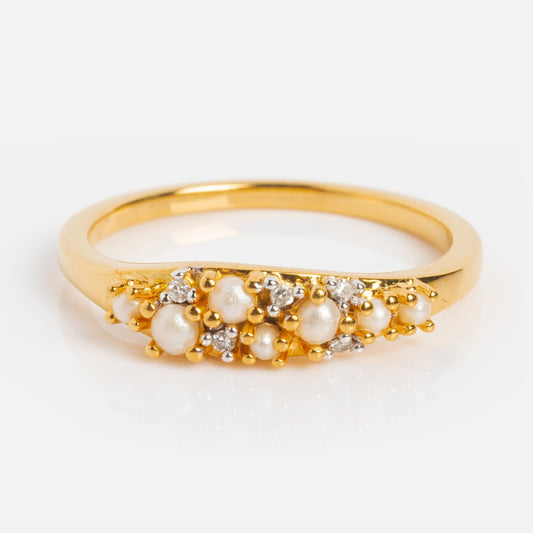 The Madeline Pearl and Diamond Scatter Ring is a vintage-inspired 14k gold vermeil band, featuring clustered small white pearls and diamond accents in an organic, textured design displayed on a white background.