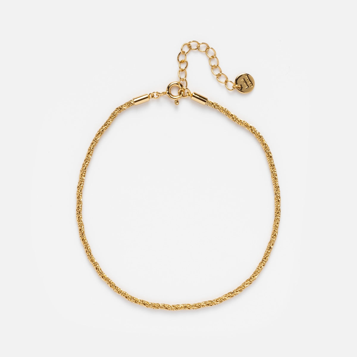 The Essential Gold Chain Anklet Sample is a delicate 14k yellow gold plated anklet with a rope chain, adjustable extender, and small round charm, measuring 8 inches for the perfect fit, displayed on a plain white background.
