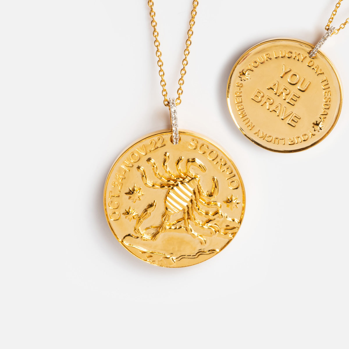 Two Vintage Inspired Zodiac Coin Necklaces: one with a scorpion and OCT 24-NOV 22 SCORPIO, the other with YOUR LUCKY DAY: TUESDAY, YOU ARE BRAVE, LUCKY NUMBER: 9.