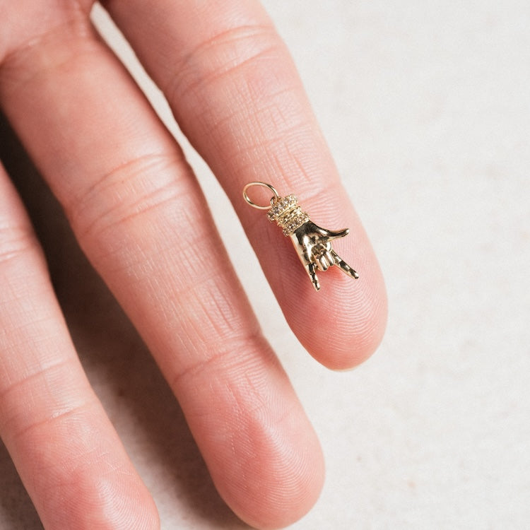 Exclusive to Local Eclectic, the Solid Gold Body Language Charm features a detailed hand-shaped pendant with textured fingers and cuff, creating a unique accessory crafted in solid gold.