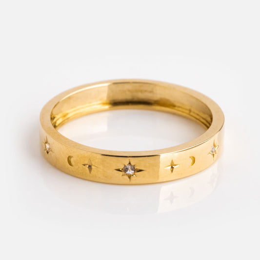 The Solid Gold Night Sky Bold Band features engraved crescent moons, stars, and white topaz set in star designs on a solid gold band, shown on a white background.