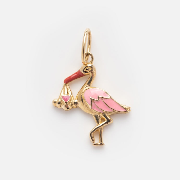 The Solid Gold Celebration Charm, crafted in 9k yellow gold with pink accents, features a stork holding a bundle adorned with a pink heart—a beautiful engraved charm representing new beginnings and perfect for special occasions.