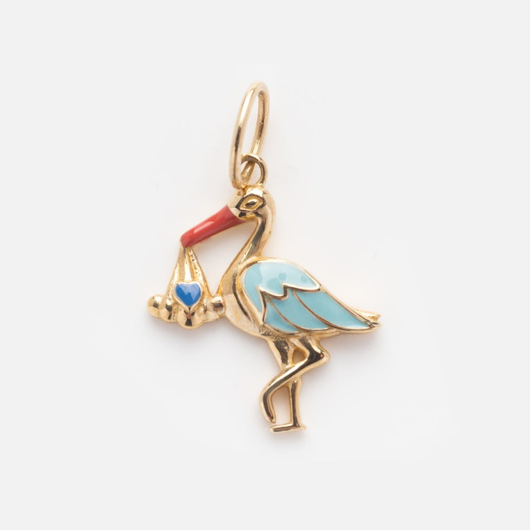 The Solid Gold Celebration Charm features a 9k yellow gold stork with blue wings, a red beak, and a bundle with a blue heart. It includes a round loop for easy attachment to jewelry—ideal for marking special moments.