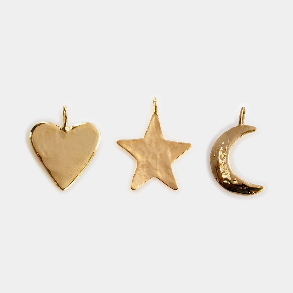 The Luiny x Local Eclectic Charms collection offers gold pendants with solid brass charms, ideal for showcasing Luiny jewelry’s distinctive style.