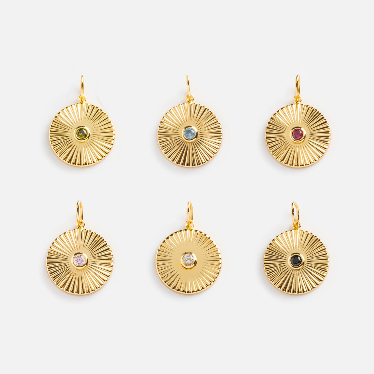 Six Mantra Empowerment Coin Charms, plated in 14k gold and arranged in two rows of three, each feature a unique colored gemstone centerpiece for a vibrant accent to this stunning mantra jewelry.