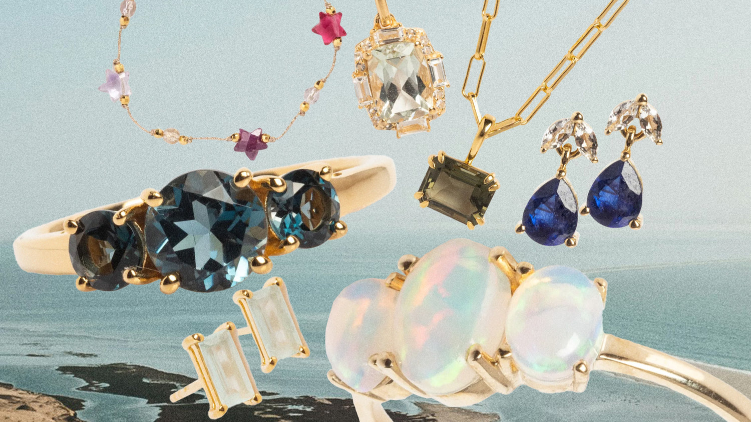 Jewelry set with rings, earrings, and necklaces featuring gemstones on a scenic background.