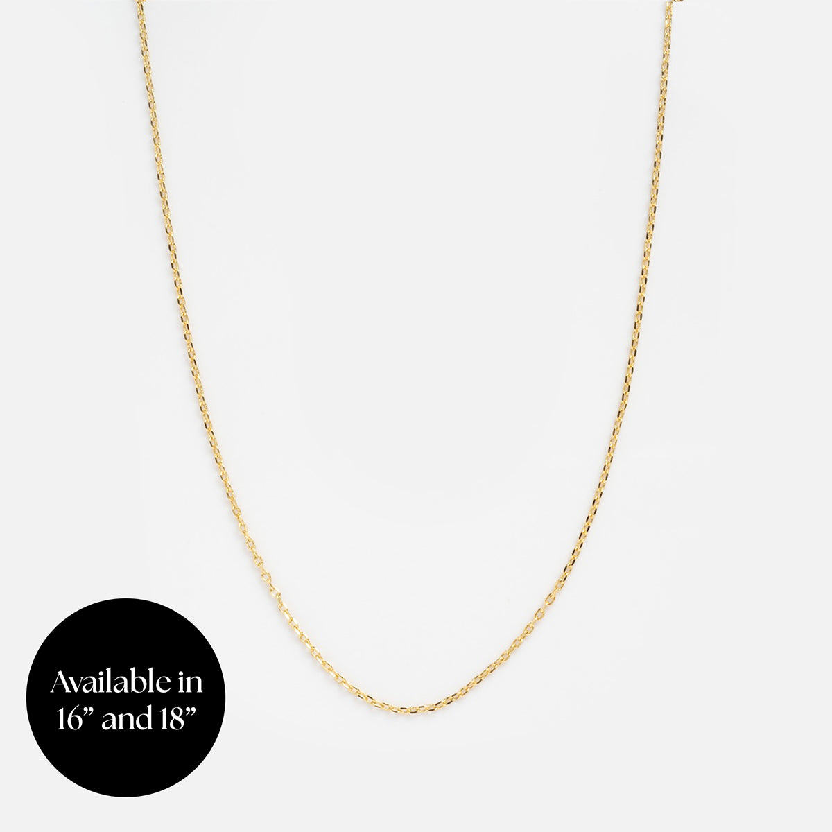 The Chain For Charms, a delicate gold-plated necklace, is shown on a plain white background with a black circle in the lower left corner that states Available in 16 and 18 in white text.