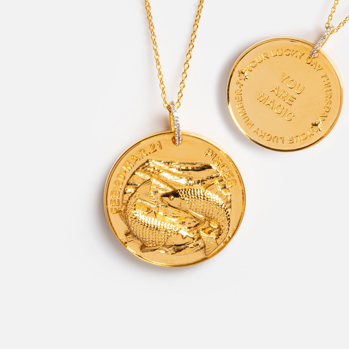 The Vintage Inspired Zodiac Coin Necklace features gold vermeil with vintage charm, engraved on the front with two fish and FEB. 20–MAR. 21 PISCES, and on the back with YOUR LUCKY DAY AT THURSDAY YOU ARE MAGIC, all on an elegant gold chain.