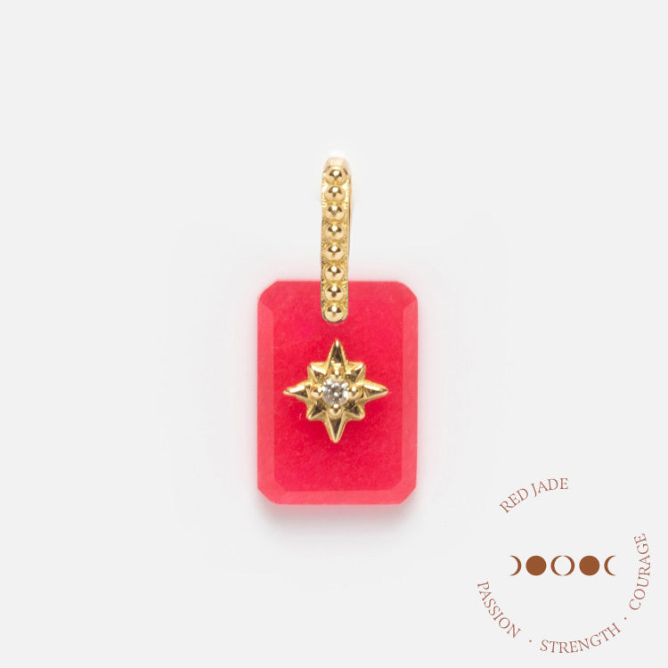 A rectangular red jade Solid Gold Crystal Amulet Charm for Manifestation features a gold and diamond starburst, hanging from a gold-studded bail. Nearby are the words: Red Jade, Passion, Strength, Courage, plus moon phase symbols.
