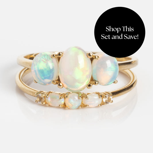 Three solid gold rings with oval and round opal gemstones form the 2025 October Capsule Opal Ring Set with Free Gift. A black circle in the corner reads: Shop This Set and Save!.