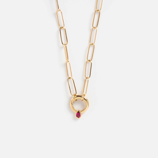 The Solid Gold Perfect Start Charm Holder Necklace features elongated links and a round, textured pendant with a central teardrop-shaped red gemstone.