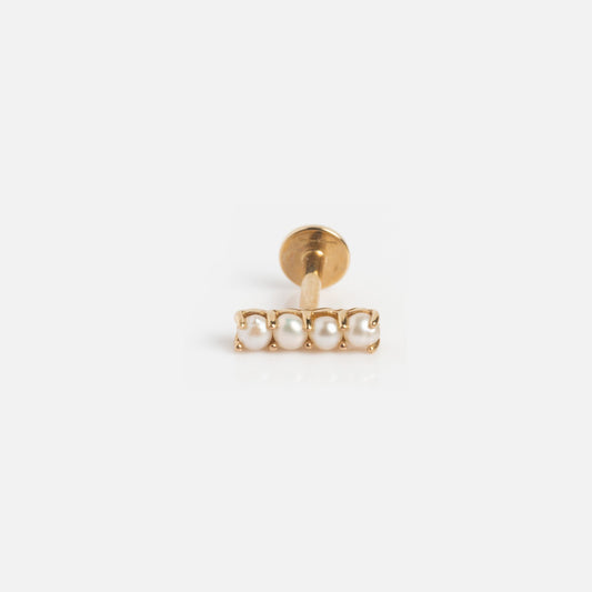 The Solid Gold Flat Back Studs are 9k gold earrings with a horizontal row of four small white pearls and a minimalist design, photographed on a plain white background—ideal for lovers of comfortable stud earrings.