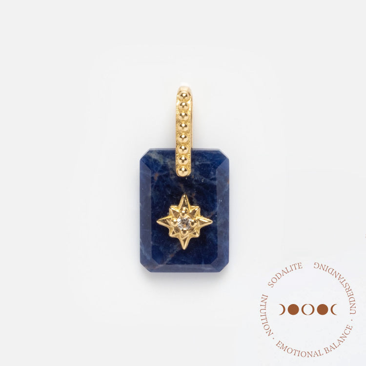 The Solid Gold Crystal Amulet Charm for Manifestation features a rectangular blue sodalite pendant with a gold star and gemstone center, symbolizing intuition, understanding, and emotional balance amid three crescent moons.