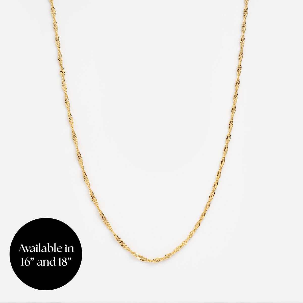 A thin vermeil Chain For Charms necklace displayed on a white background, with a black circle in the corner that reads, Available in 16 and 18.