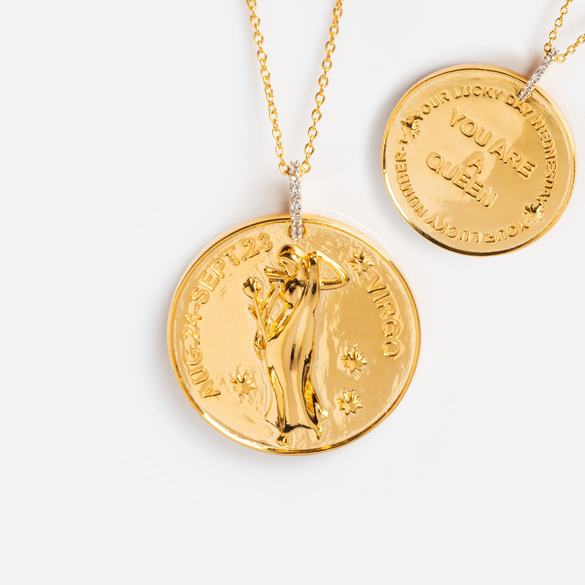 The Vintage Inspired Zodiac Coin Necklace set includes two gold vermeil chains: one with an embossed Virgo design featuring stars and dates, and the other engraved with “YOU ARE A QUEEN” and edge text—a perfect vintage charm duo.