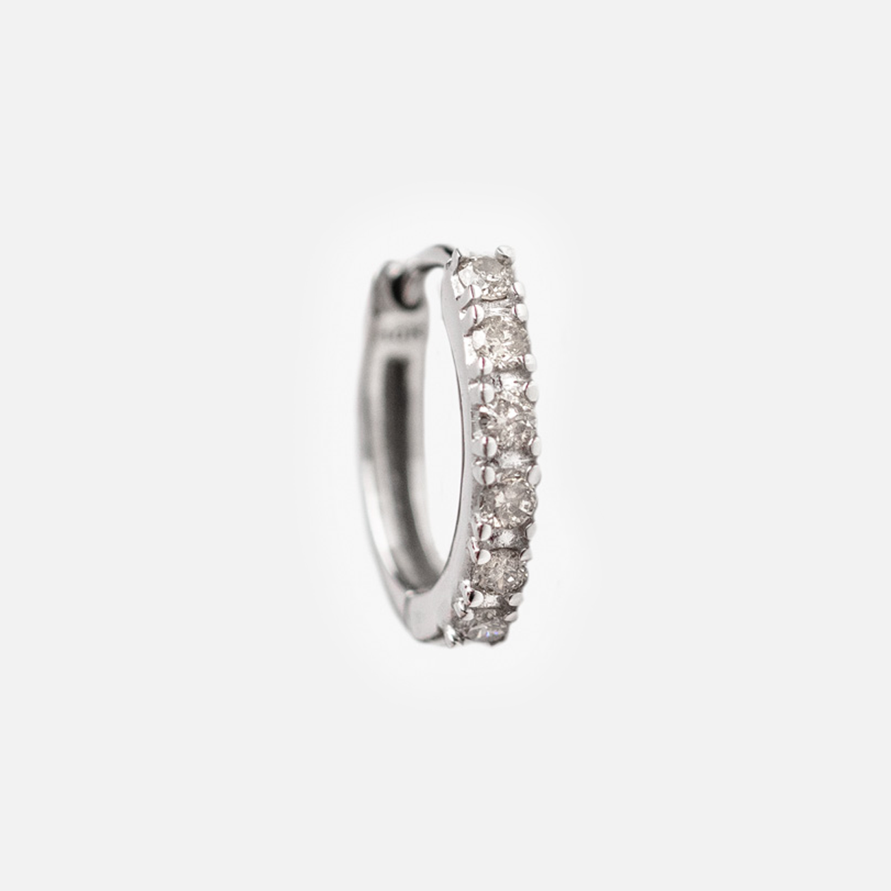 The Solid Gold Diamond Huggie Hoops, adorned with sparkling diamonds, are shown on a plain white background—ideal for anyone who loves the classic elegance of diamond hoop earrings.