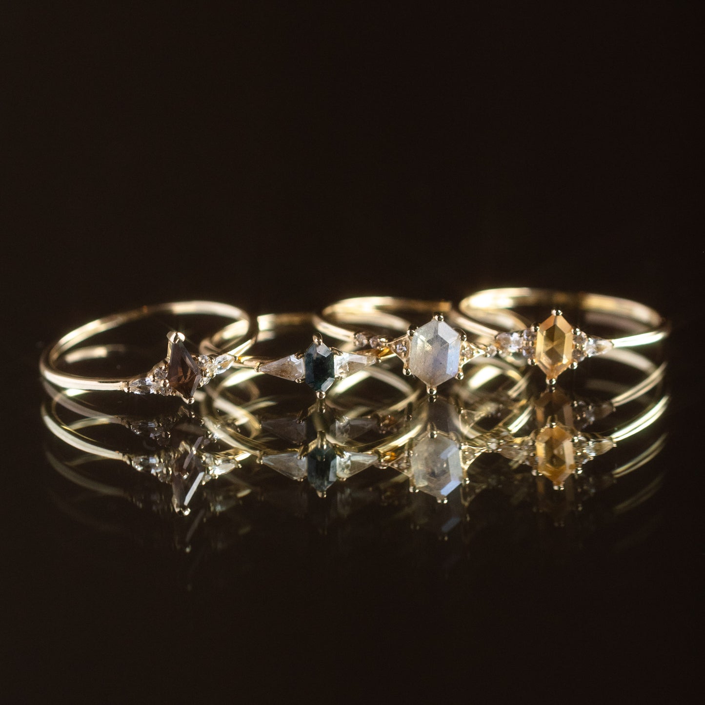 The Solid Gold Citrine Destiny Hexagon Ring for Abundance is displayed on a reflective black surface, casting a luminous mirrored effect that highlights its unique hexagonal gemstone design.