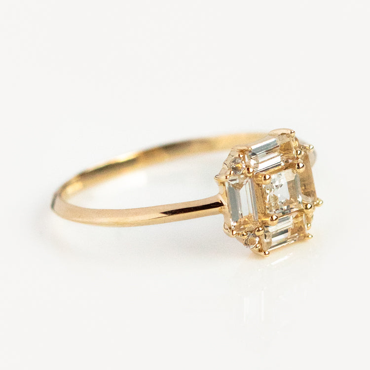 The 14k Vintage Inspired Art Deco Engagement Ring features a square cluster of rectangular and square-cut clear gems set in recycled gold, displayed against a white background.