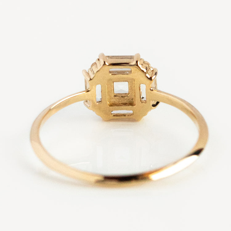 The 14k Vintage Inspired Art Deco Engagement Ring features a thin recycled gold band and an open octagonal setting with geometric details, capturing Art Deco style. Shown from the back against a plain white background.