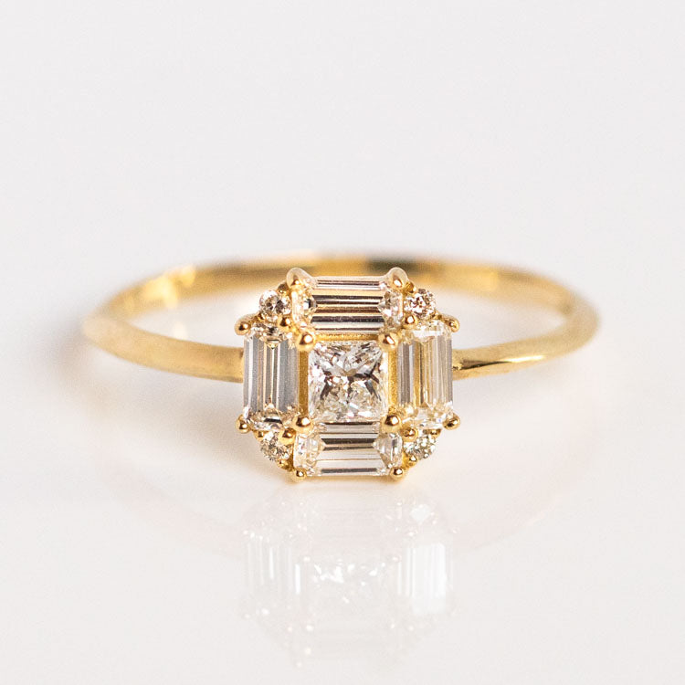 The 14k Vintage Inspired Lab Diamond Art Deco Engagement Ring, Sample Size 9, is crafted in recycled yellow gold with a square cluster of baguette and round lab-created diamonds and a central princess-cut diamond, shown on a white background.