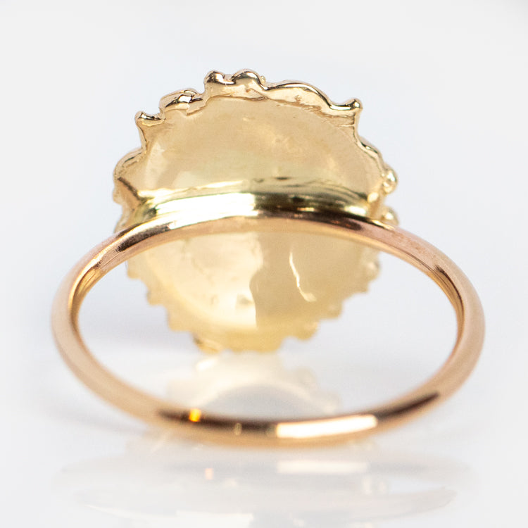 Courage the Lion Ring: Gold ring featuring a large, irregular, semi-transparent pale gemstone in a decorative bezel. Inspired by antique lion head ring designs, shown from the back on a white background for timeless charm.