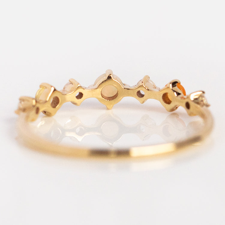 The Solid Gold Joy Acrostic Ring features an intricate geometric design with cut-out shapes and a symmetrical pattern, displayed against a white background.