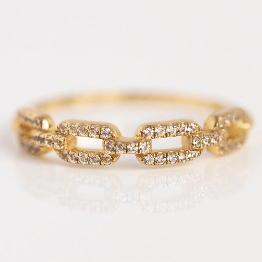 The Solid Gold White Sapphire Chunky Chain Link Ring, featuring each link adorned with sparkling white sapphires, is elegantly displayed against a white background.