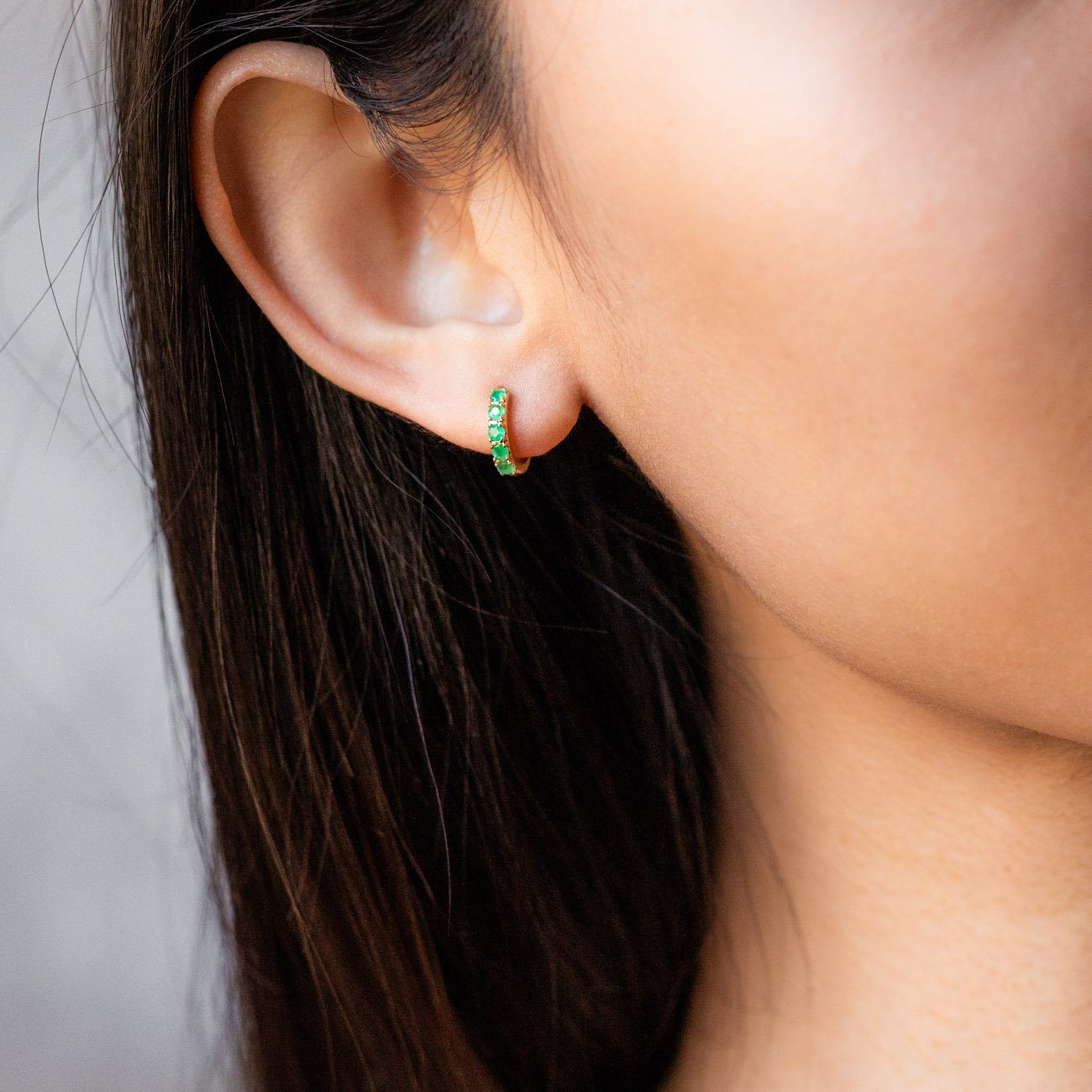 solid yellow gold emerald huggie hoops yellow gold modern jewelry