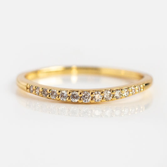 The Renaissance Curved Stacking Ring is a slim 14k yellow gold plated band with small round diamonds adorning the front, shown on a white background.