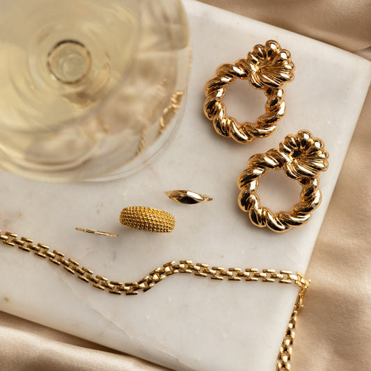 yellow gold fashion jewelry paired with white wine