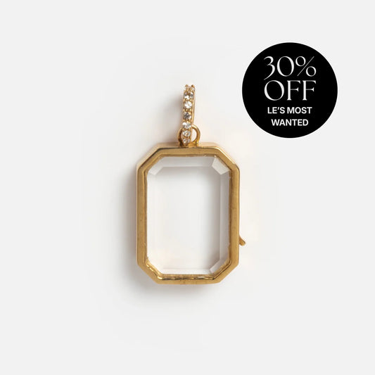The Solid Gold Glass Charm Locket features a clear center and diamond-studded loop, displayed on white. A “30% OFF LES MOST WANTED” badge is in the corner. Ideal for custom charm necklaces or personalized locket collections.