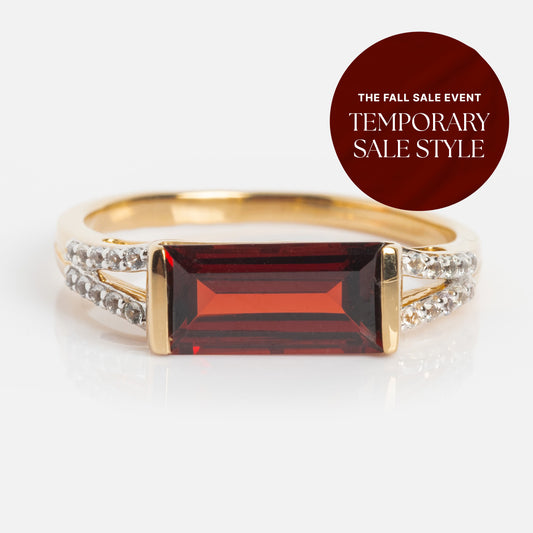 The 14k Gilded Garnet East West Baguette Ring features a rectangular red gemstone with clear stones on the band. A circular overlay says The Fall Sale Event. Local Eclectic exclusive. Limited-time sale on a dark red background.