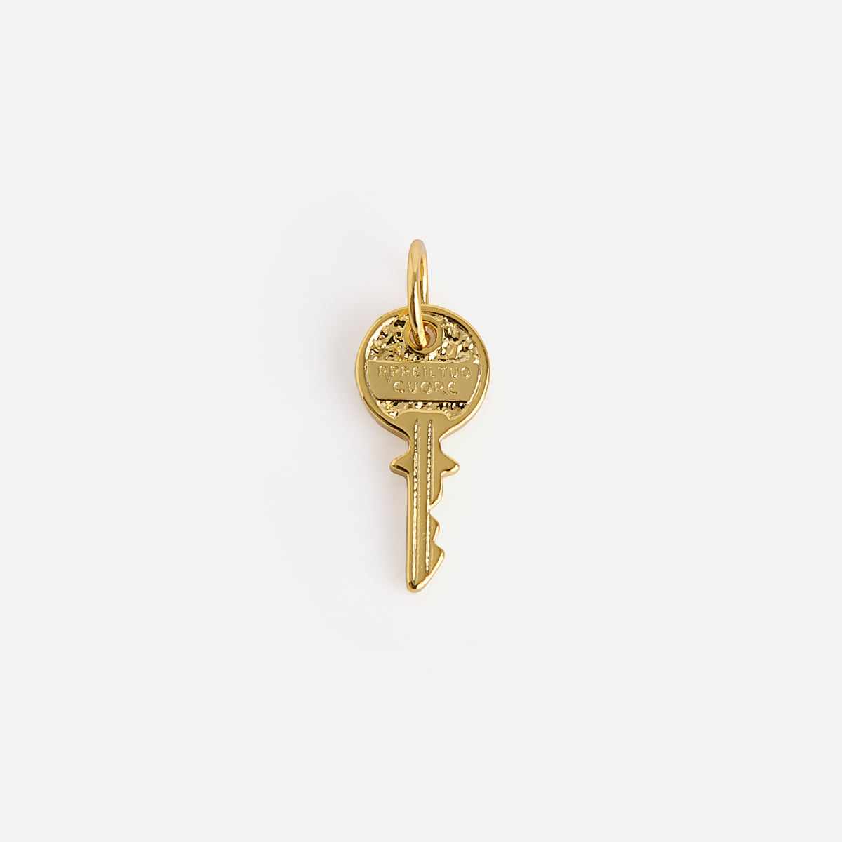 A small, gold key-shaped pendant from Charms by Mod and Jo features an oval loop, subtle engraved details, and a shiny finish, set against a plain white background.