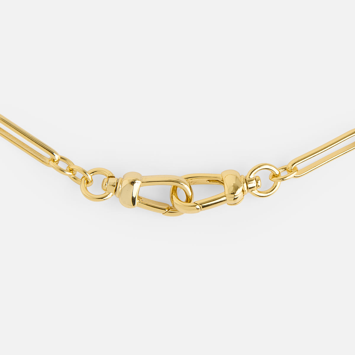 A close-up of the Liam Watch Chain Charm Holder Necklace, featuring large gold rectangular links and a unique interlocking clasp, set against a plain white background.